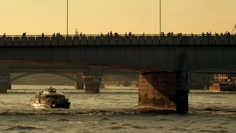 Thames Clipper riverbus passes under London Bridge at sunset Stock Footage 109113458