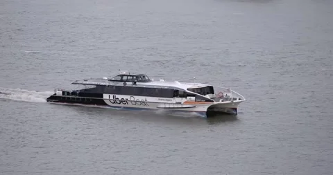 Thames Clipper/Uber Boat on River Thames in movement Stock Footage 142762873