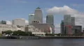 Thames River Police Boat Fast Passing Canary Wharf London Business Towers Day UK HD Footage