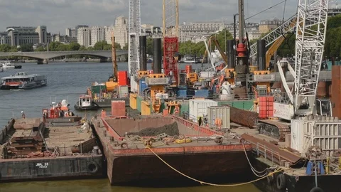 The Thames Tideway Scheme under construction with heavy machinery on barges Stock Footage 94567286