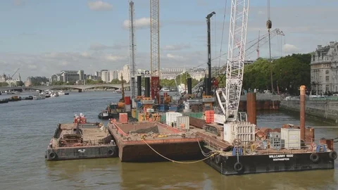 The Thames Tideway Scheme under construction with heavy machinery on barges Stock Footage 94567709