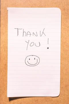 A Thank you note on a brown background. Stock Photos