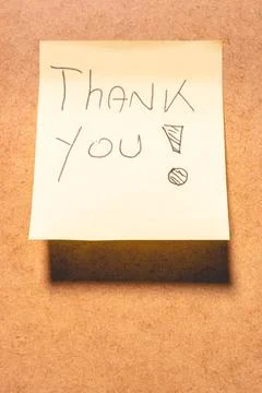 A Thank you note on a brown background. Stock Photos