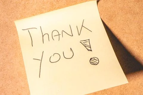 A Thank you note on a brown background. Stock Photos