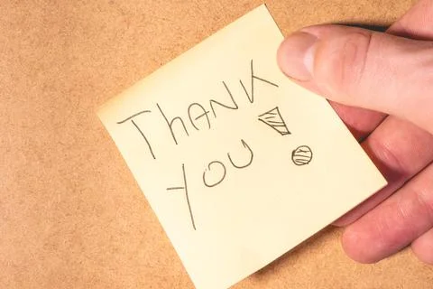 A Thank you note on a brown background. Stock Photos