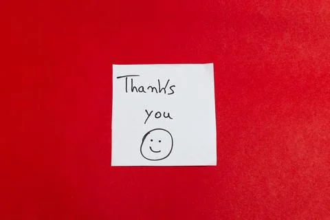 A thank you note with a smiley face drawn on it Stock Photos