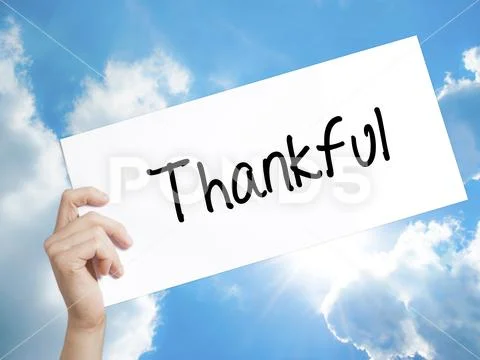 Thankful Sign on white paper. Man Hand Holding Paper with text. Stock Photos