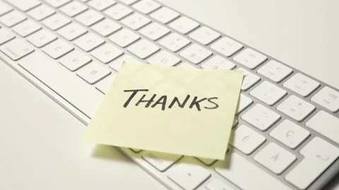 THANKS Message Pasted on a Sticky Note on a Computer Keyboard Stock Footage 170832857