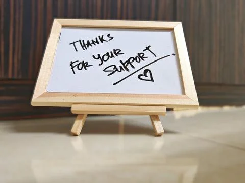 Thanks for Your Support Message on Mini Whiteboard with Wooden Background Stock Photos