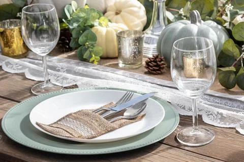 Thanksgiving day table setting with fall decorations, pumpkins on wooden tabl Stock Photos
