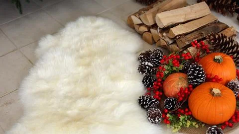 Thanksgiving decor features pinecones, red berries brighten cozy scene, pumpkins Stock Photos