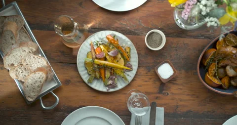Thanksgiving dinner spread with turkey being cut, carrot sides and bread in ultr Stock Footage 199458311