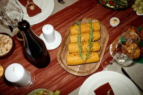 Thanksgiving Dinner Table with Roasted Corn and Wine for Holiday Celebration Stock Photos