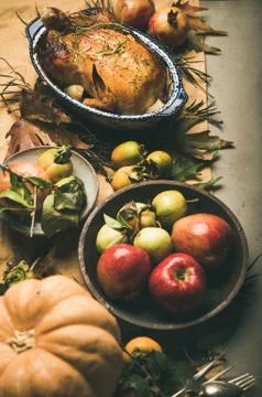 Thanksgiving dinner table with roasted meat, vegetables and fruit Stock Photos