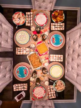 Thanksgiving Dinner Table Setting with Plates and Homemade Dishes Stock Photos