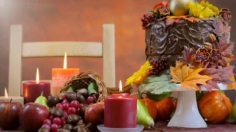 Thanksgiving Fall table setting with Autumn theme chocolate cake, fruit, corn Stock Footage 81728395