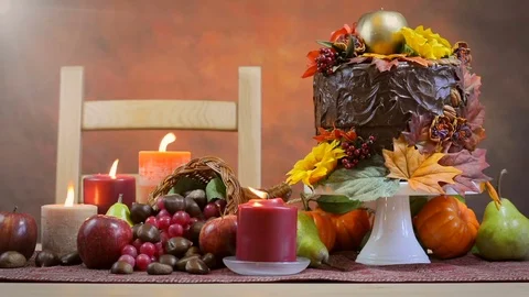 Thanksgiving Fall table setting with Autumn theme chocolate cake, fruit, corn Stock Footage 81728551