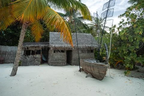 Thatch huts, coconut palms, canoe, and fish traps in Maldives 写真素材