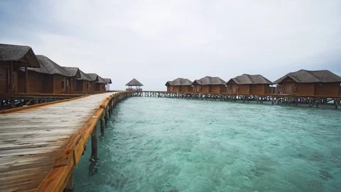 Thatched Roof Bungalows on a Pier in the Maldives Stock Footage