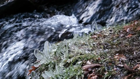 Thaw of icicles on the river, water running hard Stock Footage 148243552