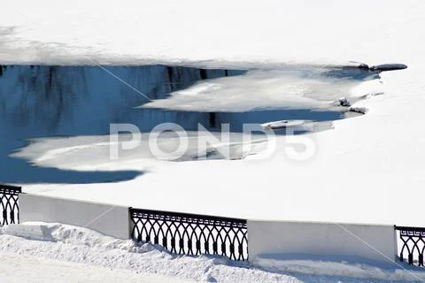 Thaw on the pond, early spring and the ice melts. Stock Photos