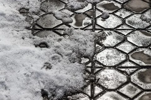 The thawed patch on the sidewalk Stock Photos