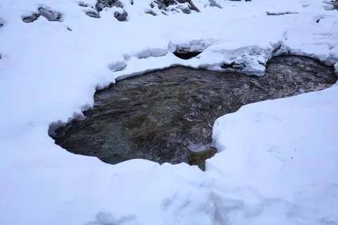 Thawed place on the mountain river of the Arshan settlement Stock Photos