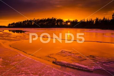 Thawing ice at sunset on Rocky Lake; Waverley, Nova Scotia, Canada Stock Photos