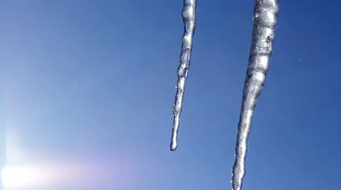 Thawing Spring Icicles Dripping on Blue Sky with Sun Shining background HD Stock Footage 35125188