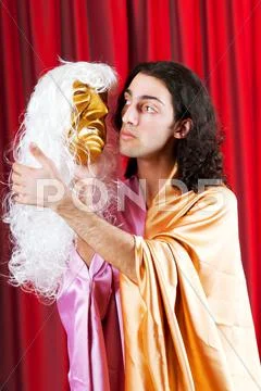 Theater concept with masked actor Stock Photos