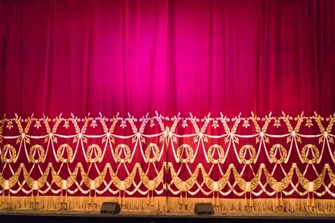 Theater red curtain with spot lighting Stock Photos