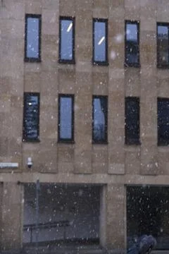 Theatre Facade Framed by Gently Falling Snow in the Urban Winter Stock Photos