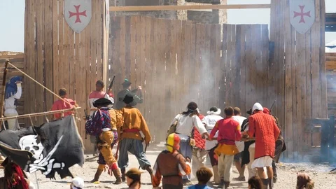 Theatrical staging of the attack of medieval pirates on a wooden fort Shots and Stock Footage 94810685