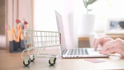 Thee boxes with ORDER text fall in shopping trolley after placing order by Stock Footage 127571812