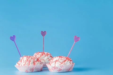 Thee colored cake on blue background Stock Photos