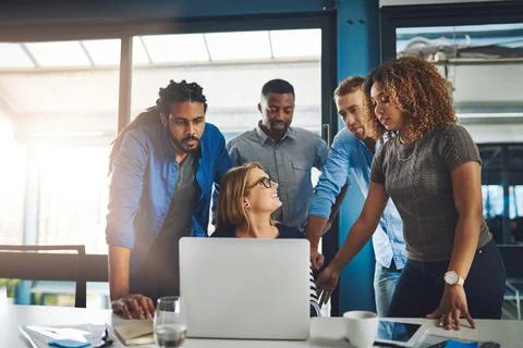 Their ideas are slowly evolving into success. a group of designers working Stock Photos