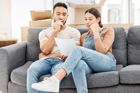 Their landlord just served them a final notice. a young couple looking worried Stock Photos