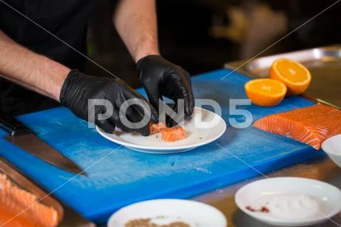 Theme cooking is a profession of cooking. Close-up of a Caucasian man's hand in Stock Photos