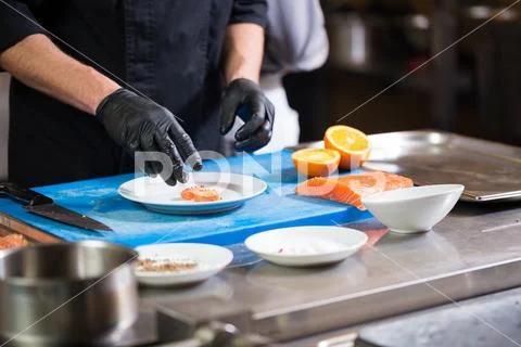 Theme cooking is a profession of cooking. Close-up of a Caucasian man's hand in Stock Photos