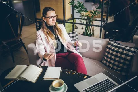 Theme modern profession female blogger. Caucasian woman with glasses and jacket Stock Photos