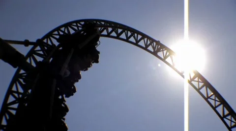 Theme Park Amusements - Looping Roller Coaster Ride - Backlit Sun HD Stock Footage