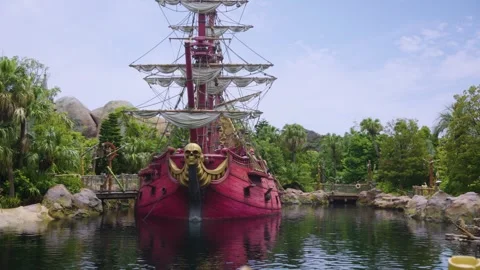 Theme Park Pirate Ship and Lagoon, Hot Summer Day with Blue Sky, Slow Pan Shot Stock Footage 342837809