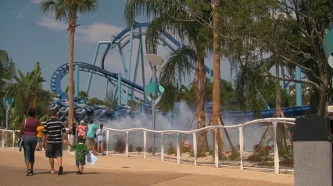 Theme Park Visitors Walking By Water Splashing Rollercoaster Video stock 21979805