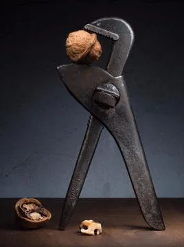 Theme Problem solution crack still life with rolling fork spanner and walnuts Stockfoto's