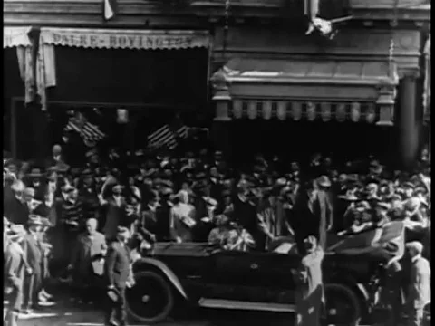Theodore Roosevelt's car is surrounded by eager crowds as he drives down a Stock Footage