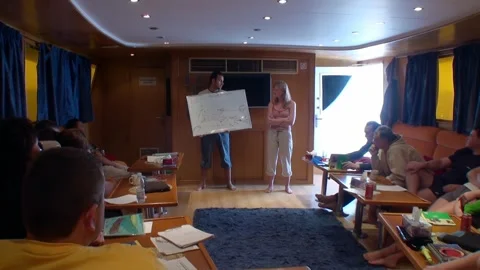 Theoretical classes on teaching diving on yacht with an instructor. Stock Footage 263836454