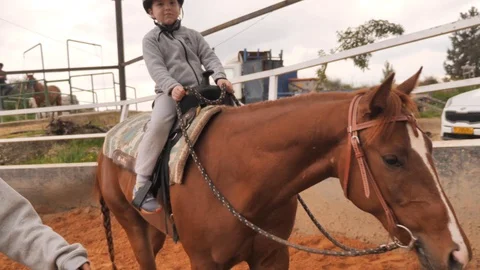 Therapeutic Riding Instructor with kid Stock-Footage 103445842