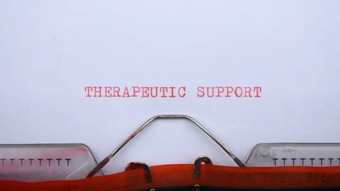 Therapeutic support - phrase printed on an old typewriter in red letters Video stock 128399482