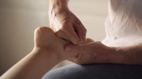 Therapist applying pressure and massaging patient's foot in clinic or spa center Stock Footage 145842353
