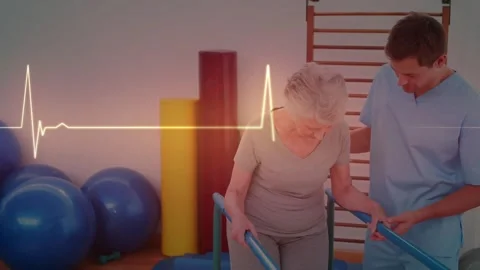 Therapist checking grip supporting, senior woman taking PT steps on parallel Video stock 330508976